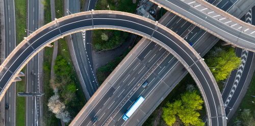 This image: a bird's eye photo of a motorway junction.
							The map: the map shows the Thrive site boundary, with an arrow from
							Dunton Lane into the site, indicating the access point. Interactive 
							map markers indicate junctions that require improvement or further 
							assessment.